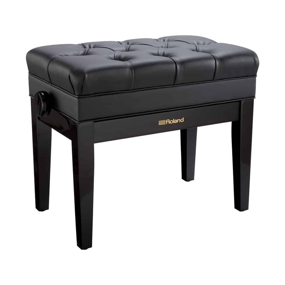 Black piano bench on white background